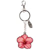 A keychain with a metal key ring, a small surfboard charm, and a large pink hibiscus flower charm.