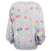 Light blue sweatshirt featuring a colorful print of summer-themed items like watermelon slices, sunglasses, hats, orange slices, flamingos, and umbrellas.