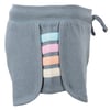 Denim blue shorts featuring a side cut-out with multicolored fabric strips: pink, orange, blue, and off white.
