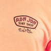 A peach-colored shirt with Ron Jon Surf Shop and Salt Life logos printed on the front.