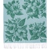 Light blue towel with green hibiscus flower and leaf prints, white fringe along the bottom edge, and a Ron Jon Surf Shop logo in the corner.