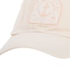 Beige baseball cap with a subtle anchor design patch on the front, featuring text at the top and bottom of the patch.