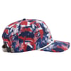 A baseball cap with an abstract red, white, and blue pattern and white embroidery. It features a brown adjustable strap and a white rope detail above the brim.