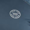 Close-up of a blue fabric with the Ron Jon Surf Shop logo. The logo includes the text RON JON SURF SHOP and EST. 1959 with a wave design in a circular emblem.