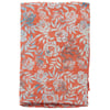 A folded piece of orange fabric with a white and light blue floral and leaf pattern.