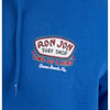 Close-up of a blue hoodie featuring the “Ron Jon Surf Shop One of a Kind Cocoa Beach, Fla.” logo printed on the chest.