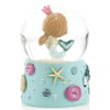A snow globe featuring a mermaid figurine with a pink crown inside, set on a light blue base decorated with colorful seashells and a starfish.