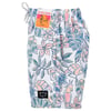 Tropical-themed swim shorts with a colorful floral and bird pattern, featuring labels at the waistband and lower hem.