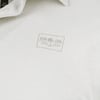 A light gray shirt featuring a small Ron Jon Surf Shop logo with a palm tree.
