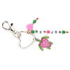 Heart-shaped keychain with beads spelling RON JON, featuring pink and green beads and a turtle charm with a pink shell.
