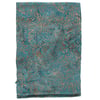 A folded piece of teal fabric with a swirling, leaf-like brown pattern.