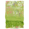 A green fabric with white, pink, and purple patterns, featuring a heart and leaf design, and green fringes on one end.