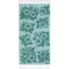 A rectangular light blue towel with white fringe on both ends, featuring a repeating green floral pattern with large hibiscus flowers and leaves.