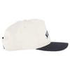 A white baseball cap with a black brim and partial embroidered text visible on the front, photographed from the side.