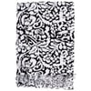 A black and white patterned fabric with abstract designs and fringed edges is neatly folded.