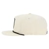 Side view of a beige baseball cap with a flat brim and a black embroidered patch on the front.