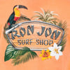 T-shirt design showing a toucan, tropical leaves, flowers, and a wooden sign with Ron Jon Surf Shop text.