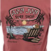 A graphic on a shirt shows a dog lounging in a beach chair by the ocean under a sunset, with palm trees and Ron Jon Surf Shop Cocoa Beach text above and below.