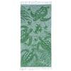 A green beach towel featuring illustrations of sea turtles swimming underwater, with Ron Jon Surf Shop printed in one corner and fringes on both ends.