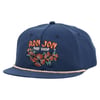 Navy blue cap with Ron Jon Surf Shop embroidered in orange, featuring floral design and a rope detail on the brim.