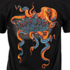 Black t-shirt featuring an orange octopus wrapping its tentacles around a sign that reads Ron Jon Surf Shop Cocoa Beach, FL.