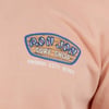 Close-up of a peach-colored T-shirt with a RON JON SURF SHOP logo and PANAMA CITY BEACH text.