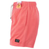 Coral pink shorts with elastic waistband, side pocket, and drawstring. Two labels are attached: one near the hemline and another at the waistband.