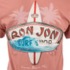 Close-up of a Ron Jon Surf Shop t-shirt featuring a surfboard and logo with palm trees in the background, labeled with Cocoa Beach, Fla. and Est. 1959.