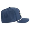 Side view of a blue baseball cap with a patch on the front and a white rope detail above the brim.