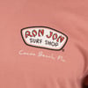Close-up of a pink shirt featuring the Ron Jon Surf Shop logo and Cocoa Beach, Fla. text.