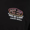 Logo on a black shirt featuring Ron Jon Surf Shop, One of a Kind, and Cocoa Beach in colorful text.