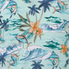 Patterned fabric with tropical fish, palm trees, ocean waves, and orange flowers on a light blue background.