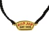 Black braided bracelet with a gold emblem reading Ron Jon Surf Shop in red and black text.