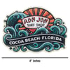 Sticker featuring the Ron Jon Surf Shop logo with waves and a sunset, and the text Cocoa Beach, Florida. The sticker measures 4 inches wide.