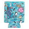 Blue can cooler sleeve with colorful, playful graphics including a shark, puffer fish, duck, sunglasses, surfboards, and Ron Jon Surf Shop logos on a geometric patterned background.