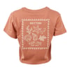 Terracotta-colored t-shirt with white sea-themed illustrations, including a starfish and shells, and text that reads Rhythm and Ron Jon Surf Shop.