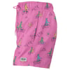 Pink shorts with dinosaurs surfing on waves, holding surfboards. Features a drawstring waist and a small logo patch.