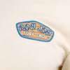 Close-up of a beige t-shirt featuring a Ron Jon Surf Shop logo and Long Beach Island, NJ text on the front.