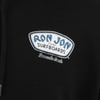 Close-up of a black garment with a Ron Jon Surfboards logo featuring the text Ron Jon Custom Surfboards, Pensacola Beach.