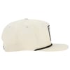Cream-colored baseball cap with a curved brim, viewed from the side. The cap features a black-edged patch on the front.