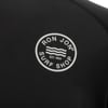 Close-up of the Ron Jon Surf Shop logo printed in white on a black garment. The logo features waves and the text RON JON SURF SHOP EST. 1959 in a circular design.