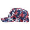 Side view of a baseball cap with a red, white, and blue abstract pattern and a white rope along the brim.