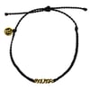 Black braided bracelet with gold-colored charm reading RonJon in reverse and small round gold-colored pendant with a P.