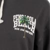 Close-up of a black shirt featuring Pensacola Beach and Ron Jon Surf Shop text with a green palm tree graphic.
