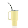 Yellow insulated mug with a handle, clear lid, and stainless steel straw against a white background.