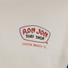 Logo on a shirt that reads Ron Jon Surf Shop, Cocoa Beach, FL with a red and white design.
