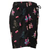 Black shorts featuring colorful dinosaurs, cacti, and pineapples printed all over.
