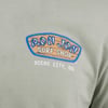 T-shirt with Ron Jon Surf Shop, Ocean City, MD logo on a gray green background.