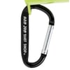 Close-up of a black carabiner with RON JON SURF SHOP printed on it, attached to a green object.