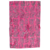 A piece of pink fabric featuring a repeating pattern of dark gray fern leaves.